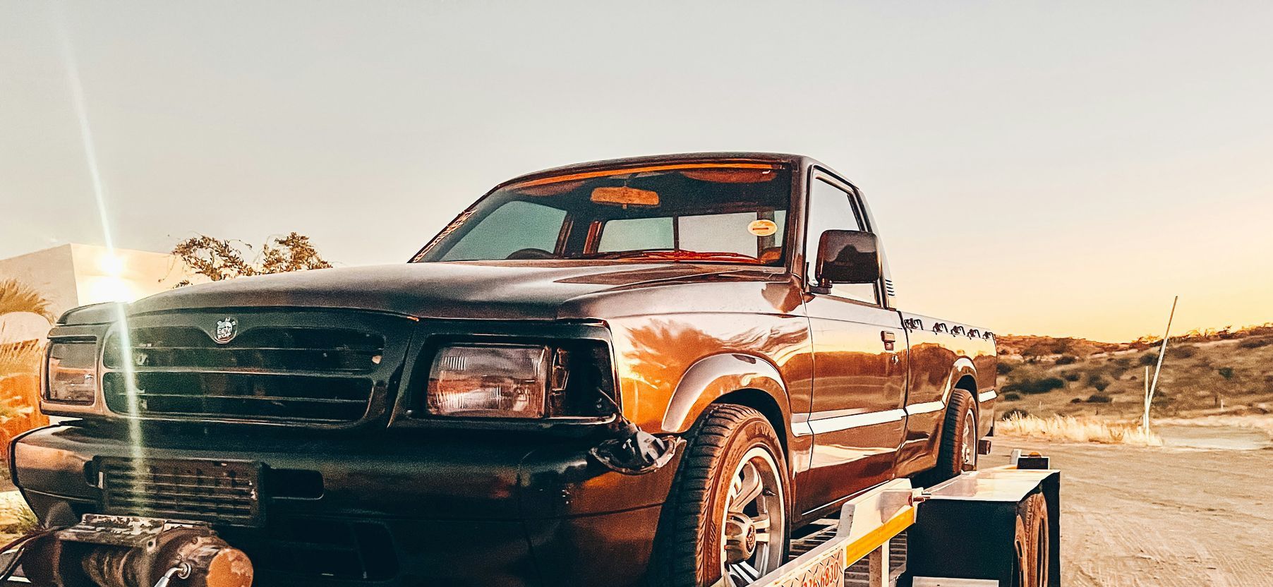 a truck is being towed on a flatbed trailer